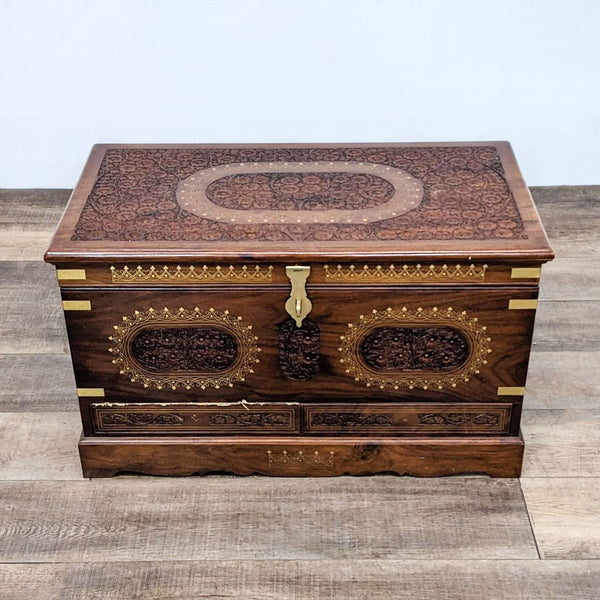 Alt text 1: Reperch wooden trunk with two decorated drawers, brass hardware, and intricate designs on the top and front.