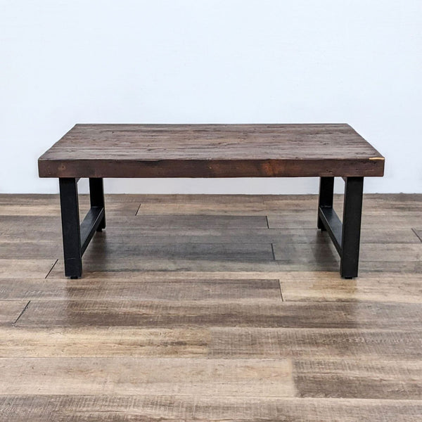 Reclaimed pine wood coffee table by Reperch with rustic finish, displaying knots and hairline cracks, on a wooden floor.