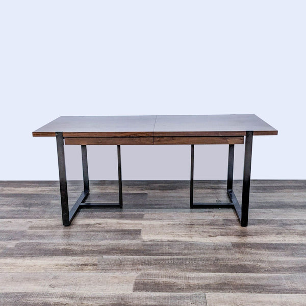 Article brand modern wood finish 72" conference table with black metal frame and built-in leaf for extra length on wooden floor.