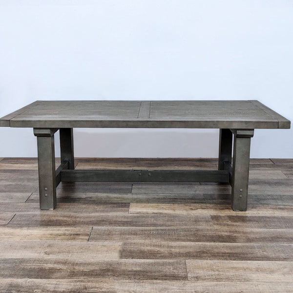 Farmhouse style Reperch dining table with wood and veneer, trestle base, on wooden floor.
