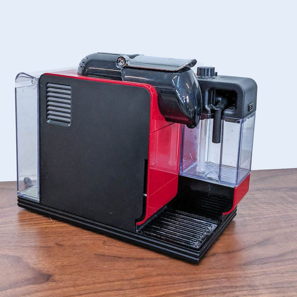 DeLonghi Lattissima Touch EN520 Nespresso machine in red and black on a wooden table, side view showing transparent water tank.