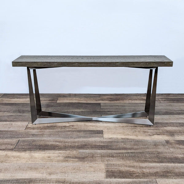 Reperch wood top console table with visible grain on a minimalist metal base against a wooden floor.
