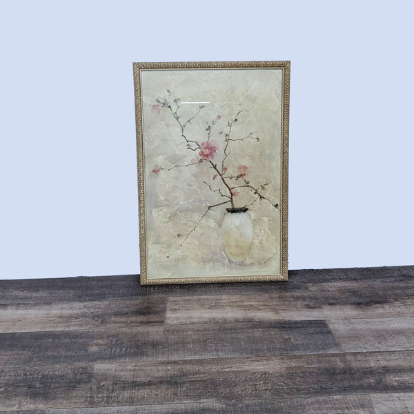 Art print featuring cherry blossoms in a vase, set in an ornate gold frame, by Reperch, on a wooden floor.