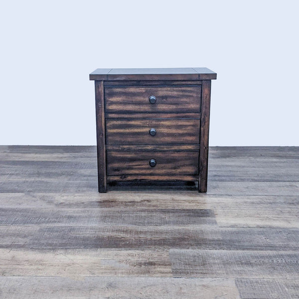 Alt text 1: Reperch end table with planked top and sides, features three drawers with wooden knobs on a wooden floor.