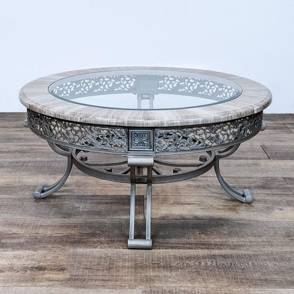 Reperch brand decorative coffee table with metal base and glass top with intricate apron design on a wooden floor.