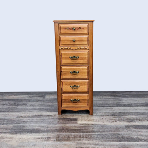 Broyhill wooden tallboy dresser with six drawers and antique brass handles on a gray wood floor, warm finish. 