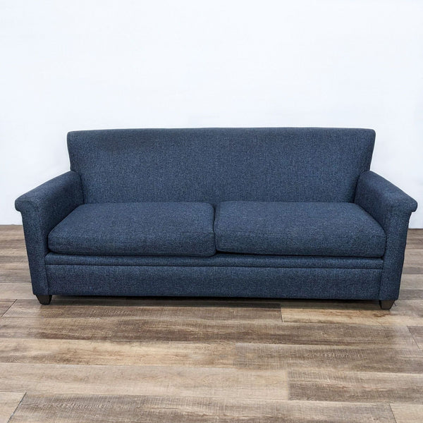 Crate & Barrel loveseat featuring straight back, turned arms, and dark finish feet, upholstered in dark gray fabric.