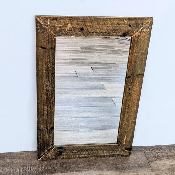 Reperch brand rectangular wall mirror with a wide rustic wooden frame, leaning against a wall on wooden flooring.