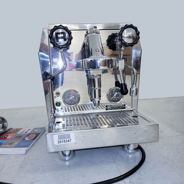 Front view of a Rocket Espresso Machine with gauges, a portafilter, and a polished finish on a countertop.