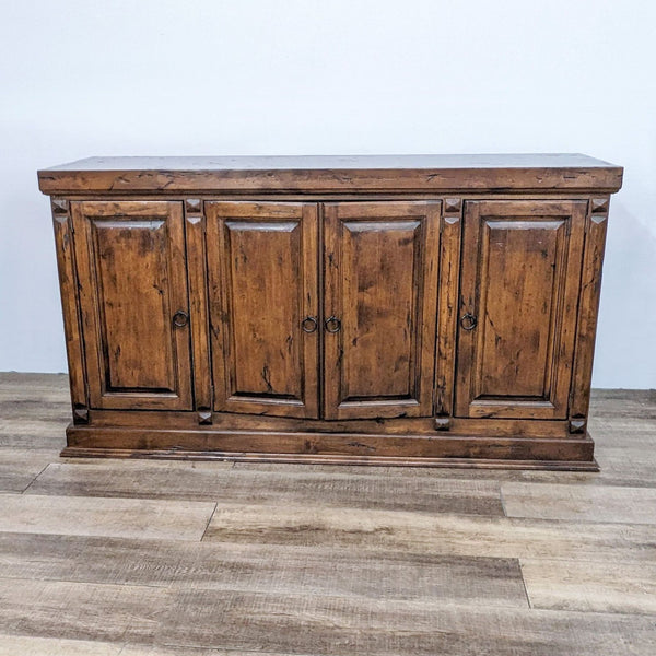 Rustic Walter of Wabash sideboard with closed panel doors and metal hardware on a wooden floor.