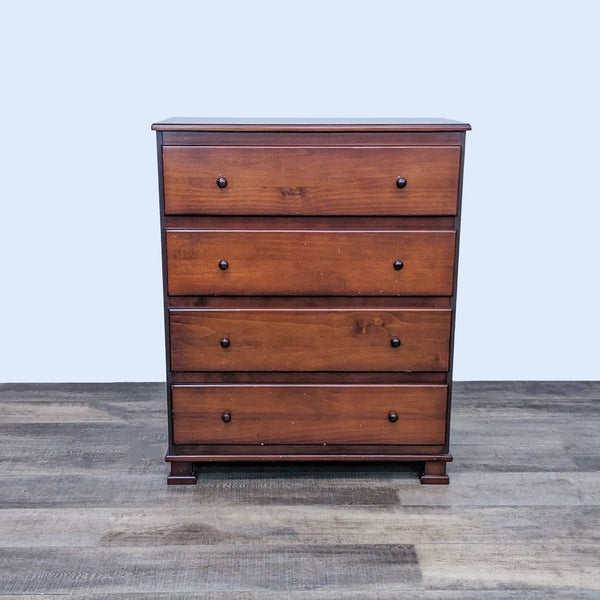 Alt text 1: A closed Million Dollar Baby four-drawer classic wooden dresser on a wood floor.