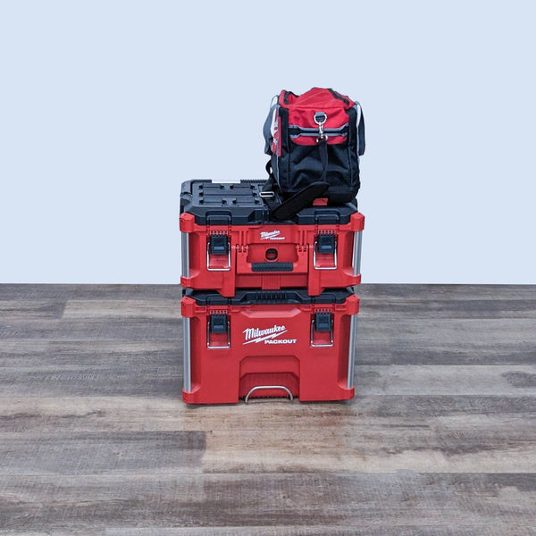 Milwaukee PACKOUT tool storage system with stackable design, featuring a tool bag on top and reinforced corners.