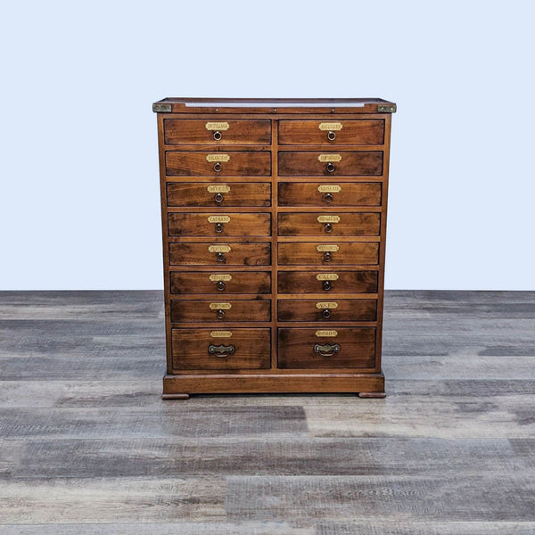 Reperch vintage reproduction chest with multiple drawers featuring French label plates and dovetail joinery, set against a grey backdrop.