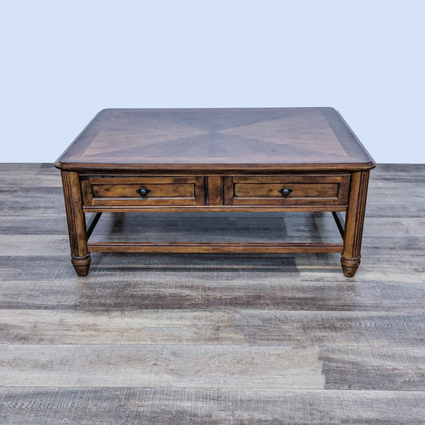 Reperch brand traditional coffee table with inlay top and two drawers, on a wooden floor.