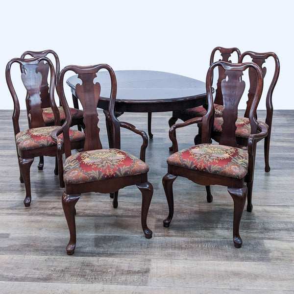 Ethan Allen classic dining set with six chairs featuring floral upholstery and dark wooden extendable table.