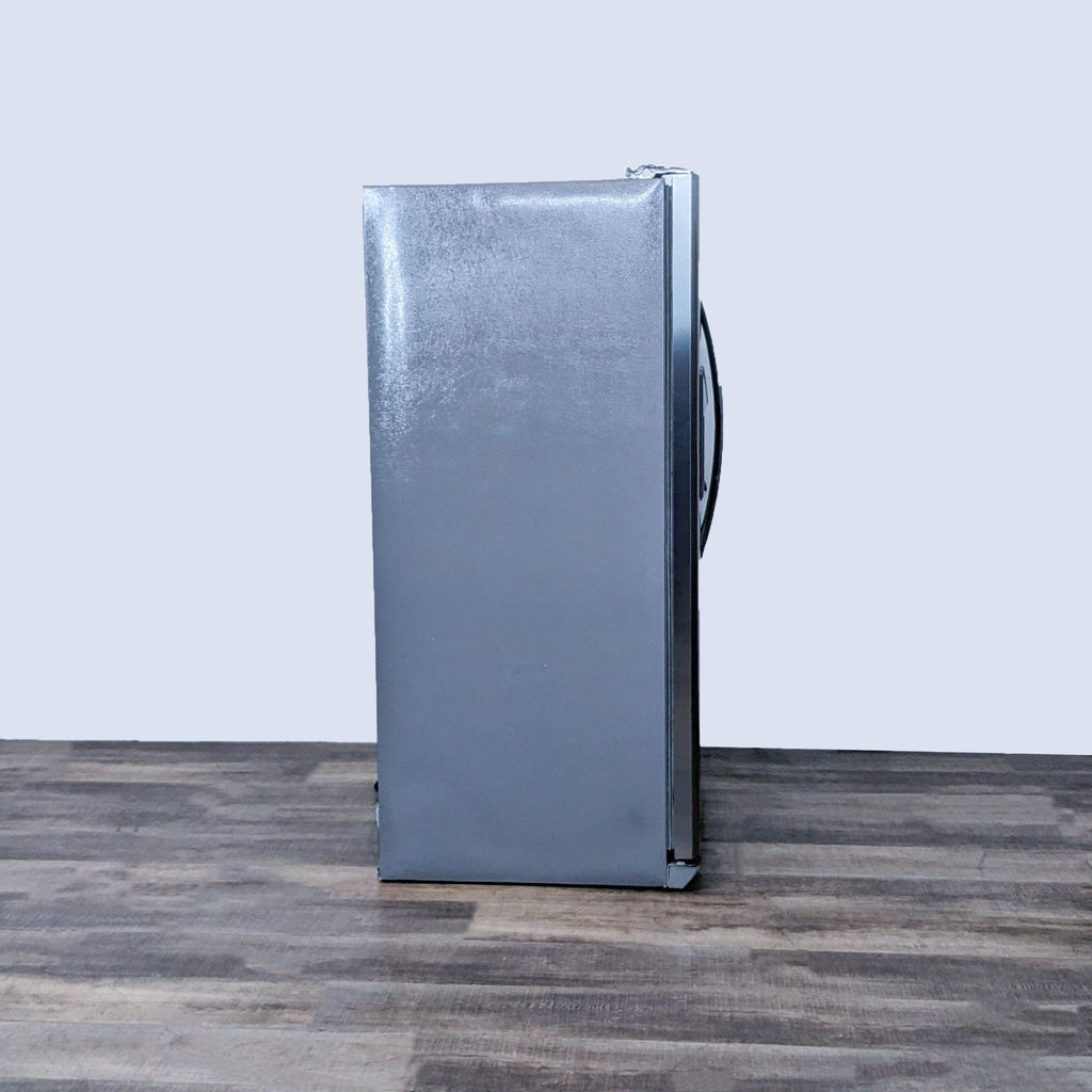 Side view of a sleek stainless steel Frigidaire side-by-side refrigerator with energy-efficient design.