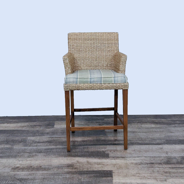 Reperch seagrass stool with green/blue plaid cushion and wood frame, front view.