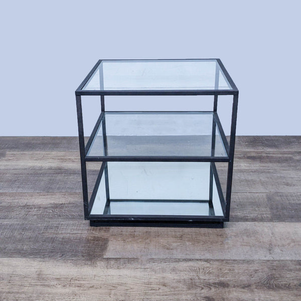 Reperch end table with a metal frame, two glass shelves, and a mirrored bottom shelf on a wooden floor.
