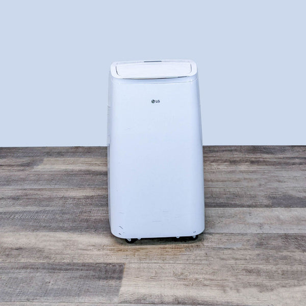 LG portable air conditioner displayed in a room, showcasing its compact and sleek white design for easy room integration.