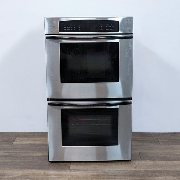 1. Front view of a Thermador Professional stainless steel double wall oven with digital controls on top and two closed oven doors.