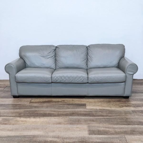 Reperch 3-seat leather sofa in alloy gray with rolled arms and dark wood feet, frontal view.