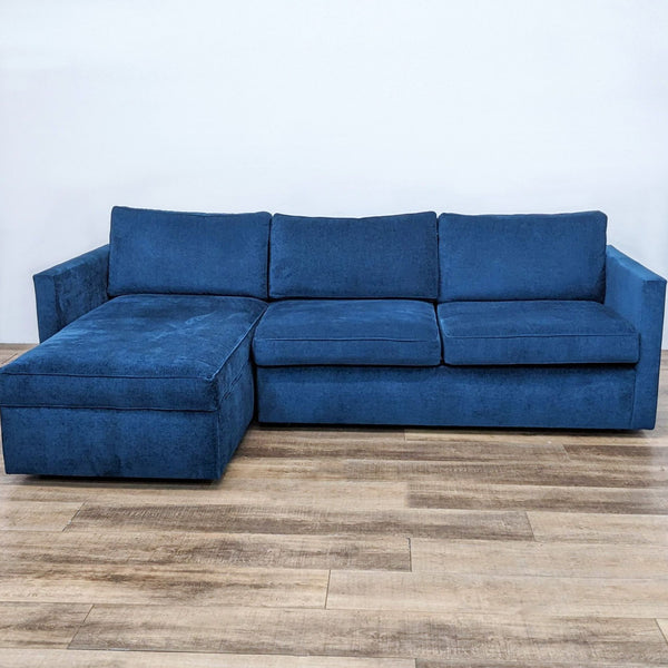 Alt text 1: Ink blue Harris two-piece sectional with chaise by West Elm, featuring distressed velvet fabric, narrow arms, and clean lines, on a wooden floor.
