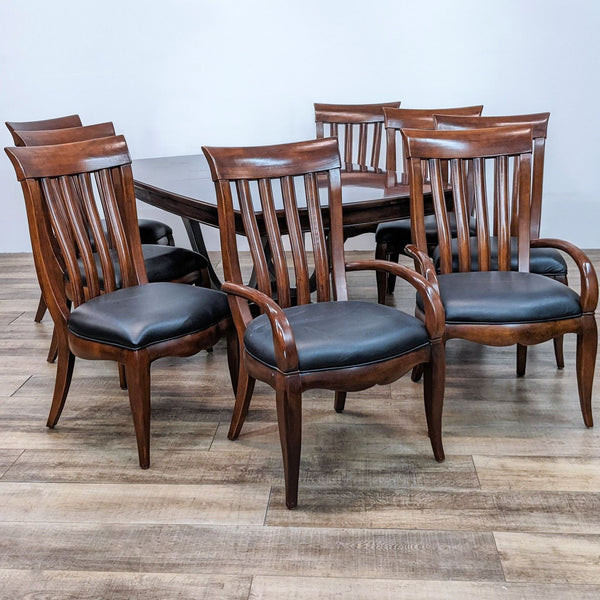 Bernhardt 9-piece dining set with contemporary wooden chairs, black leather seats, and a table with expansion leafs.