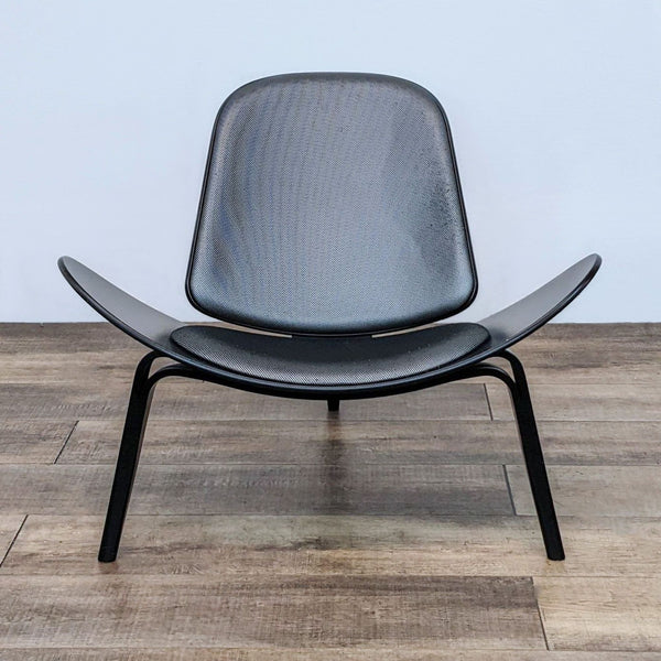 Front view of a Carl Hansen & Son Shell chair with a minimalist wood frame and mesh-textured seat.
