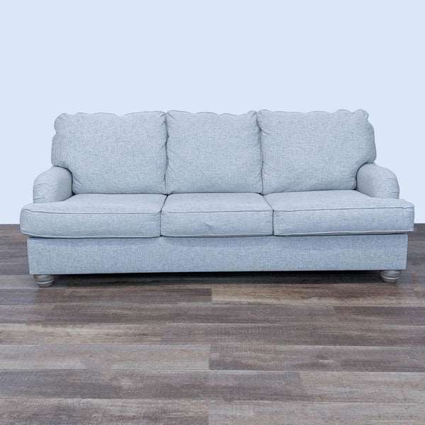 Front view of a Reperch high-back 3-seat sofa with T cushions and bun feet.