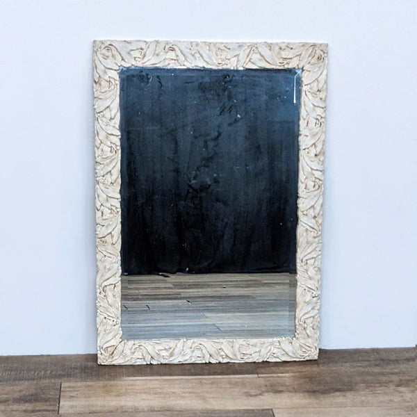 Reperch brand wall mirror with a textured, neutral-toned custom frame, shown against a wooden floor and white wall.