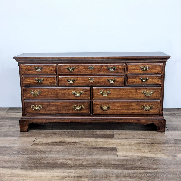 Alt text 1: Reperch classic wooden 10-drawer dresser with brass handles on a wood floor, front view, closed drawers.