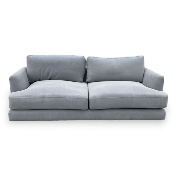 1. West Elm deep seat grey fabric sofa with plush cushions and sleek wedge arms, suitable for three people.