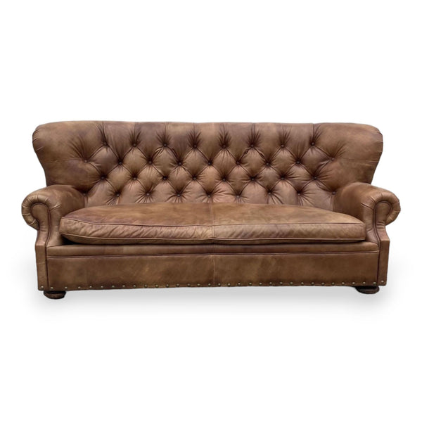 Restoration Hardware brown leather Chesterfield sofa with tufted back, bench seat, rolled arms, and nailhead accents.