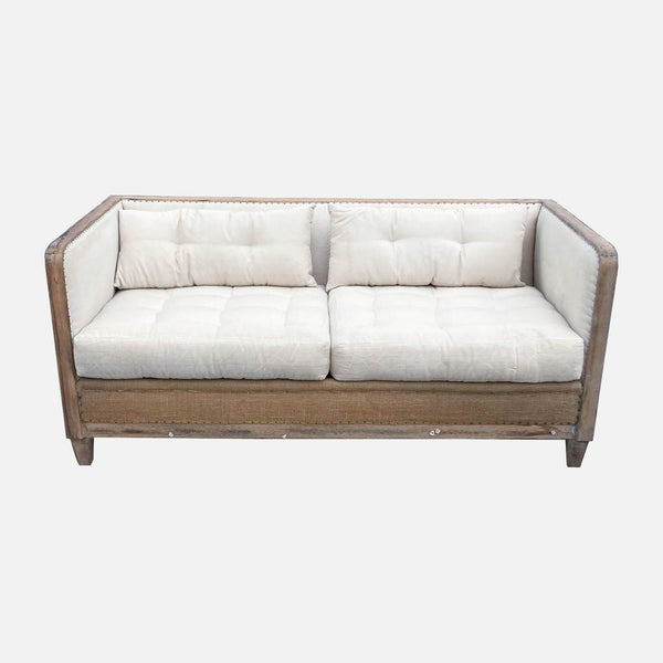 Restoration Hardware burlap and wood loveseat with white tufted cushions.