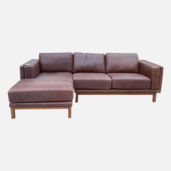 West Elm top grain leather sectional with left chaise, overstuffed arms, and wood base.