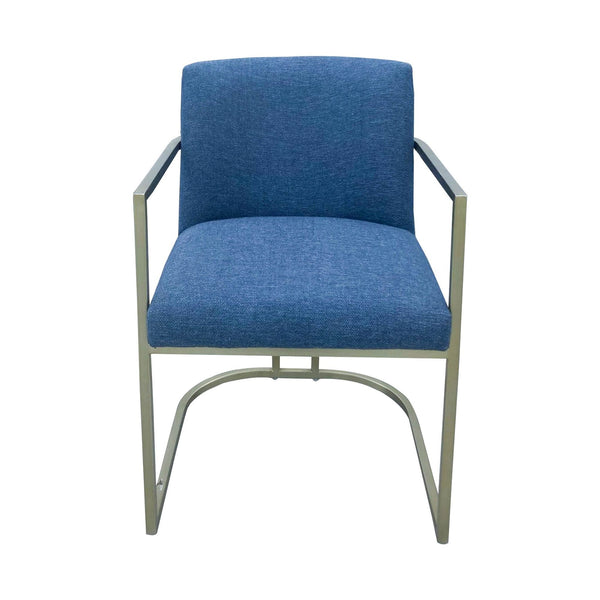 West Elm curved metal frame armchair with blue upholstered seat and back, isolated on white background.
