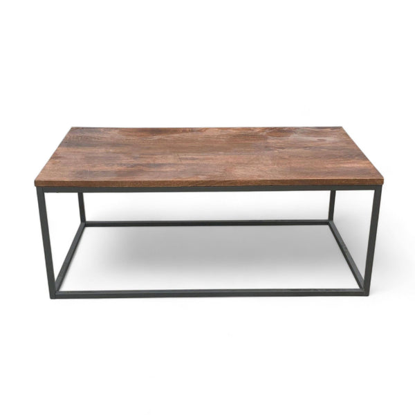 West Elm coffee table with mango wood top in walnut finish and black metal box frame.