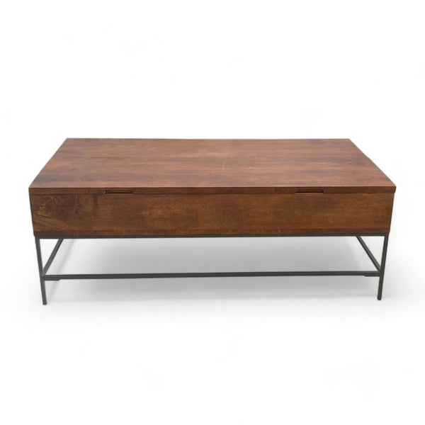 Williams Sonoma coffee table with lift top closed, on a metal frame, on a plain background.