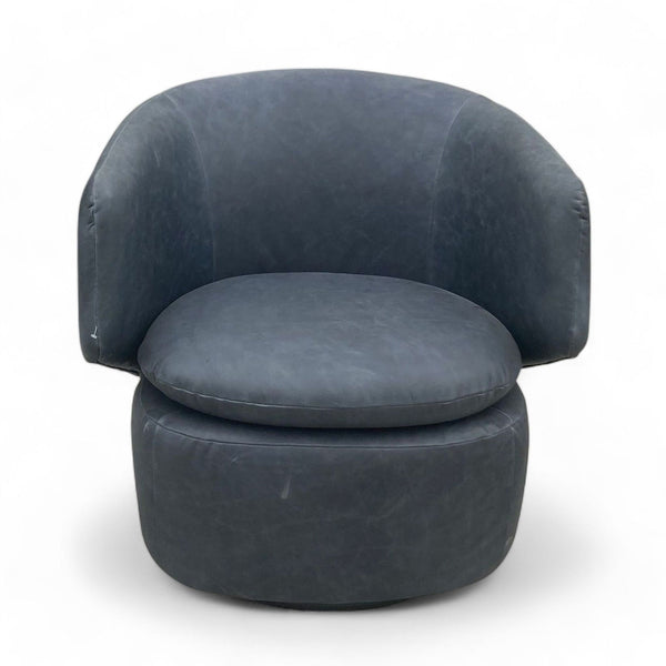 1. West Elm Crescent swivel chair with leather upholstery on a 360-degree swivel base, showcasing a modern drum chair design.