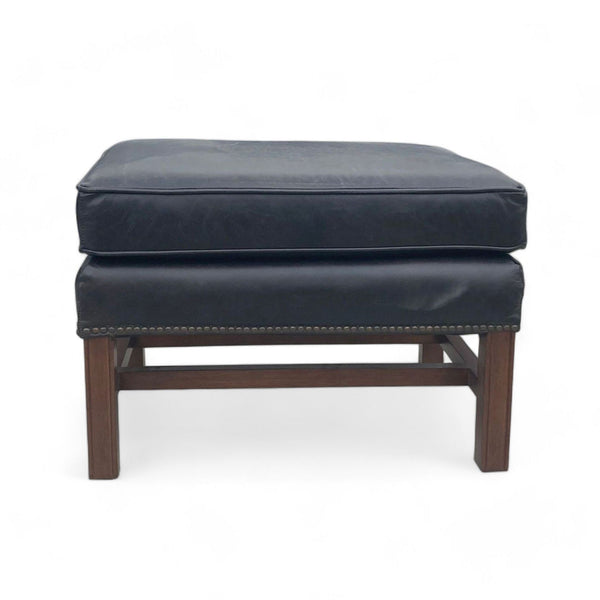 1. "Pottery Barn Thatcher Ottoman with black leather padding and nailhead detail on a wooden base."