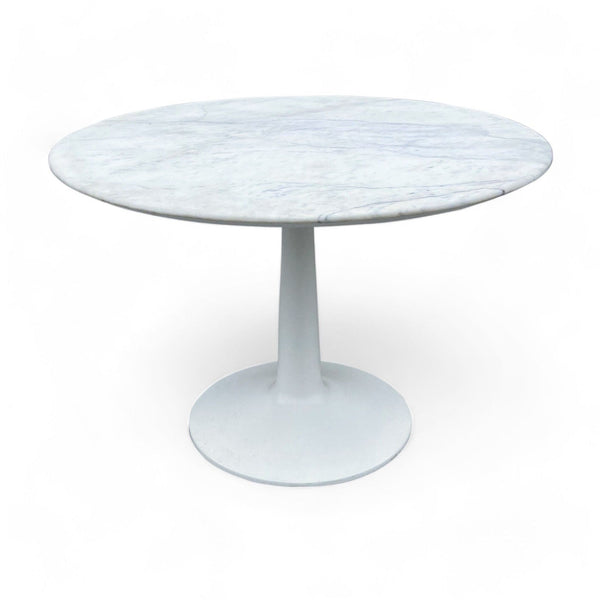 1. "Williams Sanoma Sparrow dining table with a sleek, round marble top and sturdy metal base in a neutral color palette."