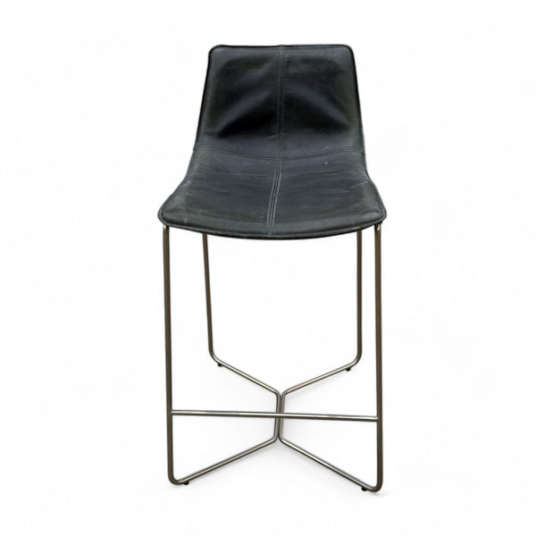 West Elm modern counter stool with a sleek black seat and gold metal frame on a white background.
