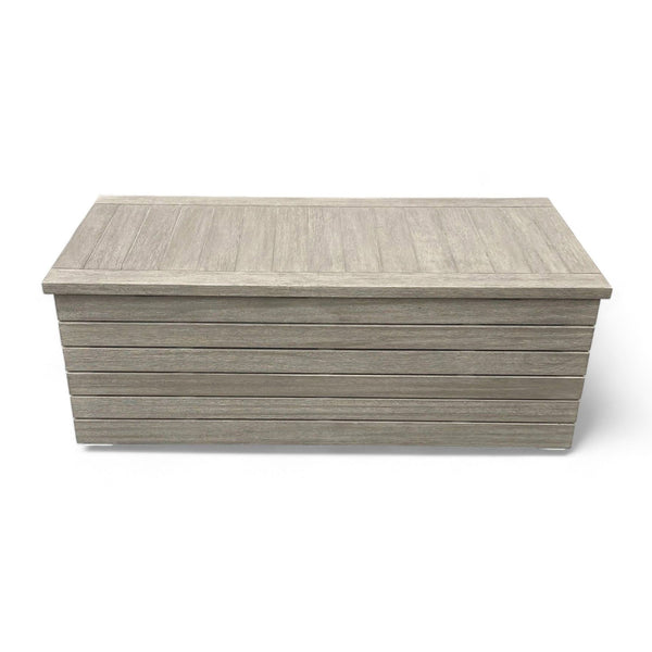 1. Closed Pottery Barn outdoor storage bench with weathered wood finish on a white background.