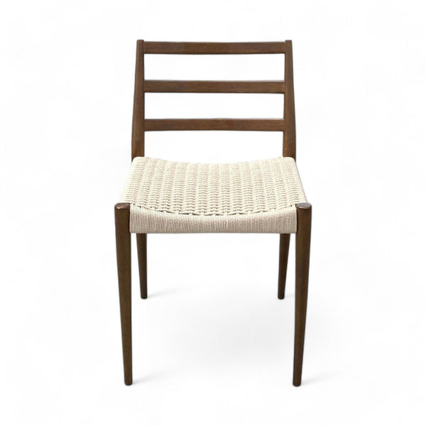 West Elm's Holland dining chair featuring a curved wooden seat, wide back slats, and tapered legs with durable woven cording.