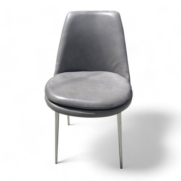 1. West Elm's Finley dining chair with a modern design, showcasing grey leather upholstery and sturdy metal legs for a sophisticated dining space.
