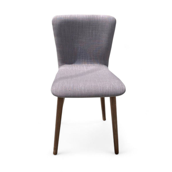 1. West Elm Boulder dining chair with a slightly pitched back and tapered wooden legs, upholstered in grey fabric on a white background.