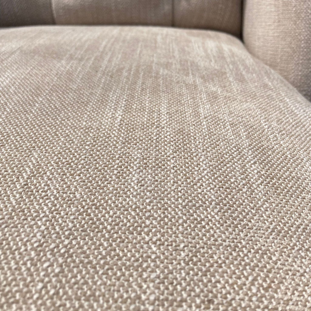 2. Close-up of the textured neutral fabric upholstery on a sophisticated Reperch wingback chair.