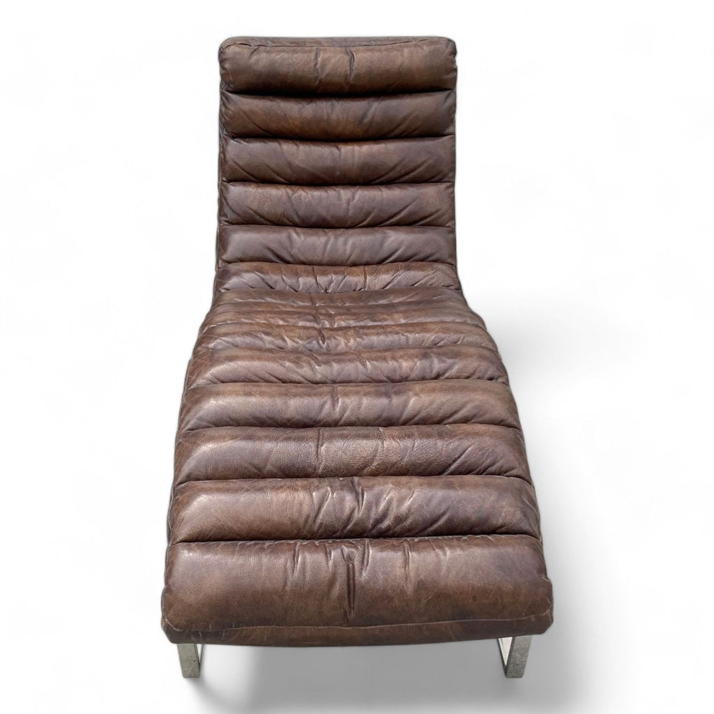 Lounge view of the Oviedo chaise by Restoration Hardware, featuring channel-stitched leather cushion and cantilevered base.