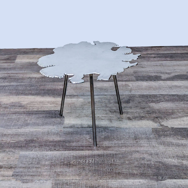 Reperch brand end table with amorphous tabletop on three metal legs against a wooden floor background.