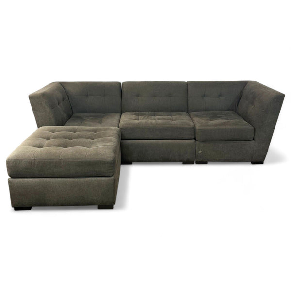 L-shaped gray sectional sofa by Jonathan Louis with tufted cushions and a chaise.